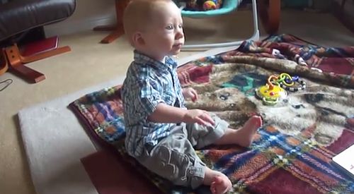 Baby_twirling_his_hands_and_toes.jpg