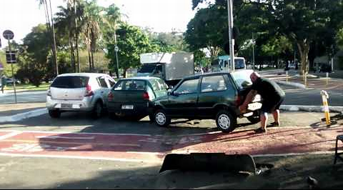 Biker_lifts_car_parked_on_bicycle_path.png